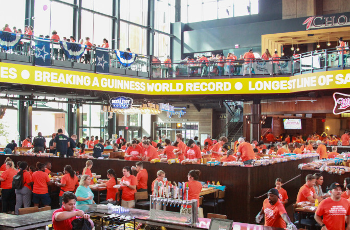 Wide shot of everyone assembling sandwiches