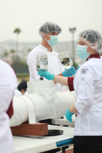 Close up of chefs filling the tank