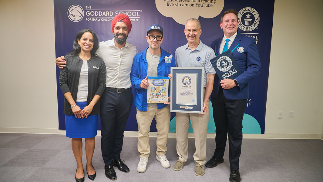 a group of people are smiling holding a guinness world records certificate