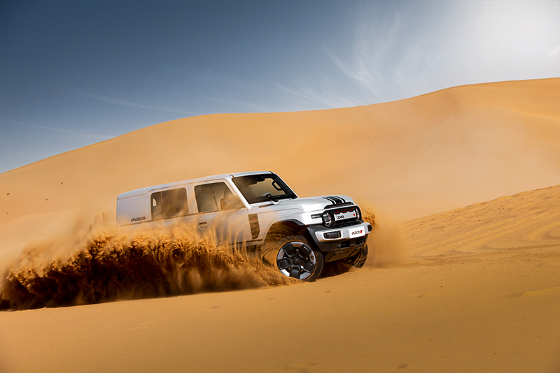 Close up of iCAR driving up sand dune
