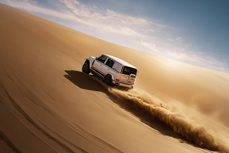 iCAR driving up the sand dune