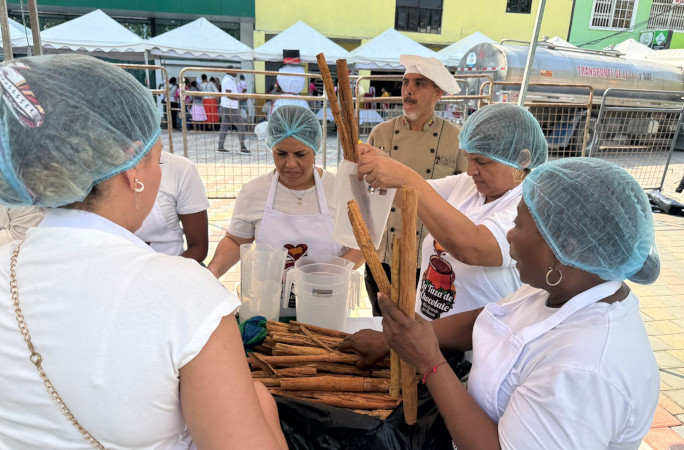 Workers breaking up cinnamon sticks