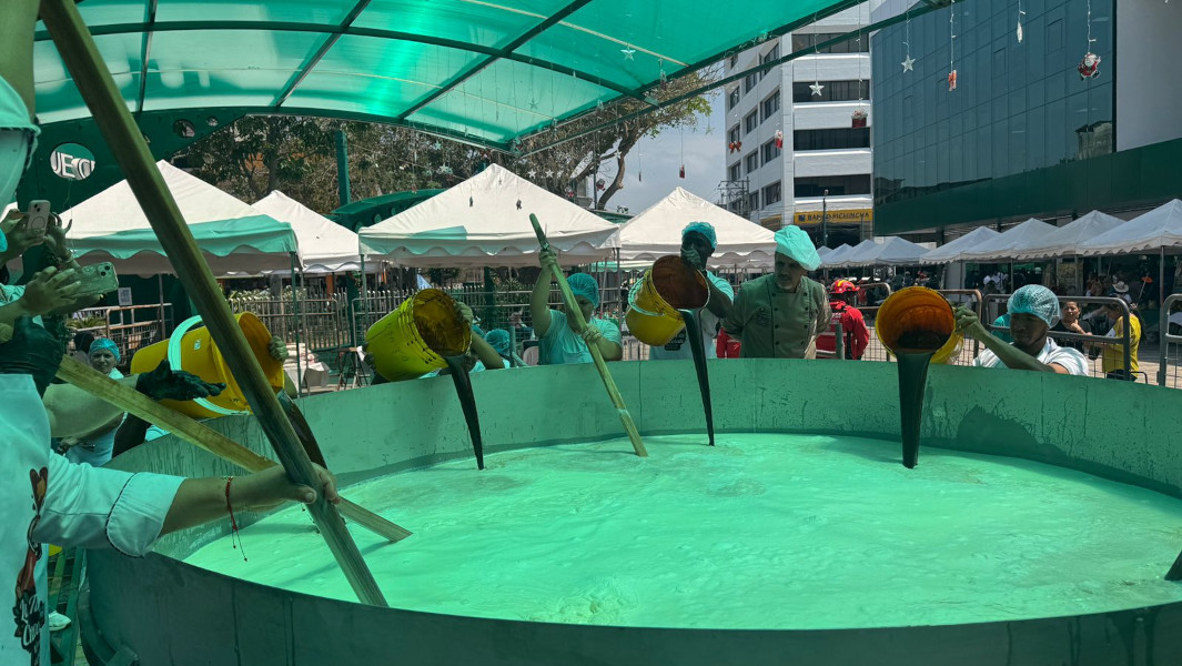 Participants pouring chocolate into the giant cup of milk