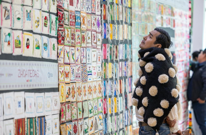 Man with fun jacket looking at the art