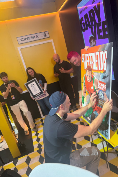 Employees setting up the comic's GWR sticker and holding the cert