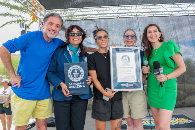 GWR Adjudicator and event organizers, smiling and holding the GWR certificate