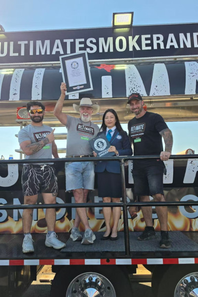Adjudicator and organizers holding certificate on the truck