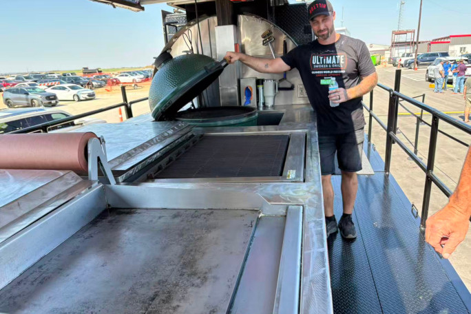 A man showing off the griddles on the truck