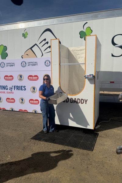 Woman smiling and dumping fries into the container