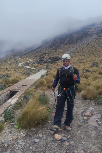 One of the male participants posing while walking on the mountain