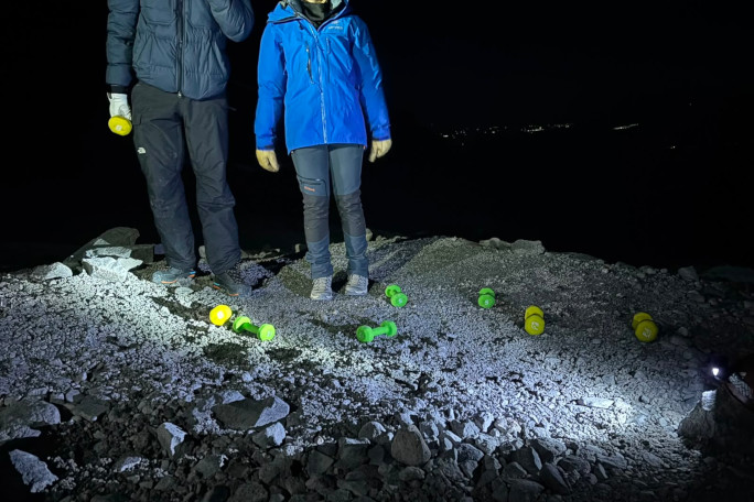 Photos of two participants and dumbbells in the night
