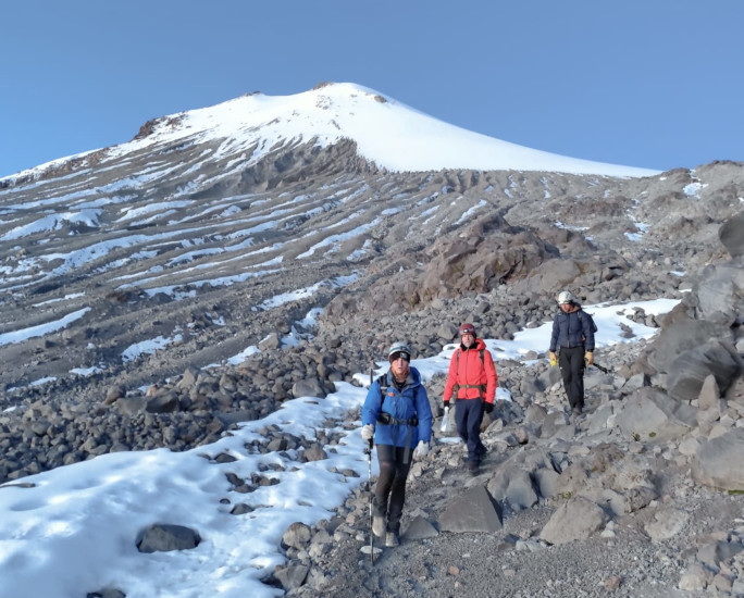 Three participants walking back down the mountain