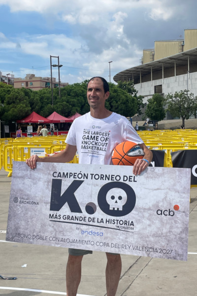 The winner of knockout basketball game holding a giant certificate