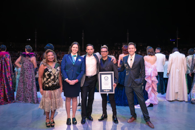 Adjudicator, organizers, and models onstage with the certificate