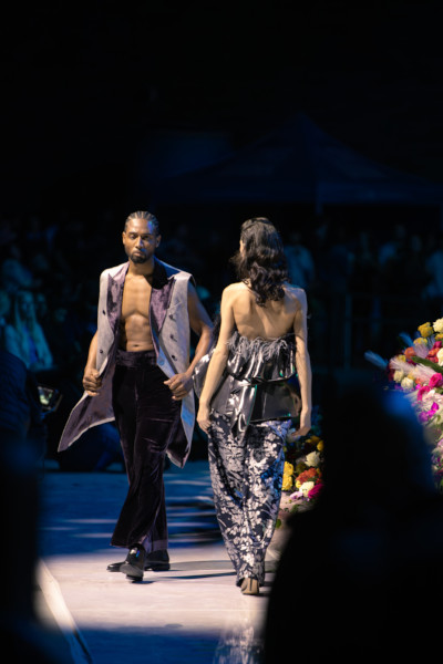 Two models walking the runway