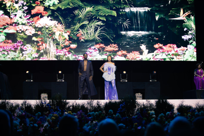 Two models posing onstage