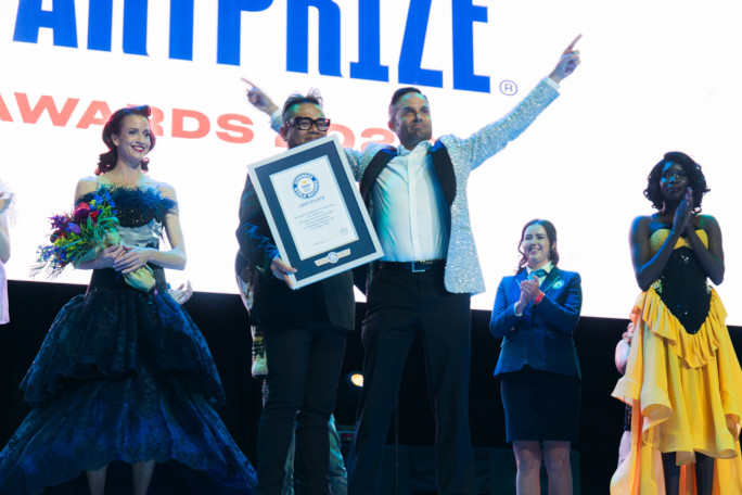 The organizers celebrating onstage with the certificate