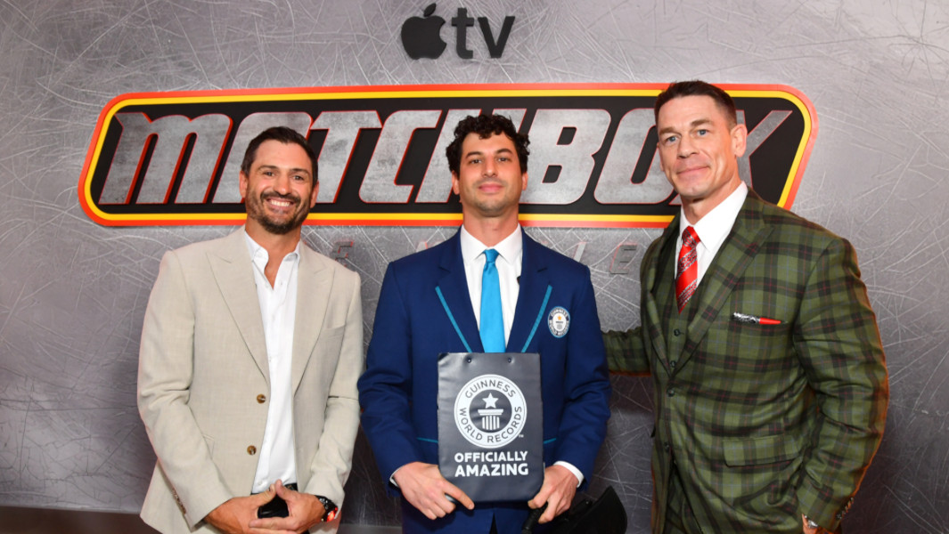 Stunt driver, GWR Adjudicator, and John Cena posing with GWR certificate at Matchbox premiere