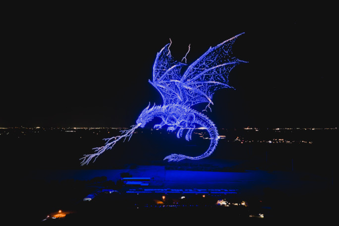 Drones forming the image of a blue dragon