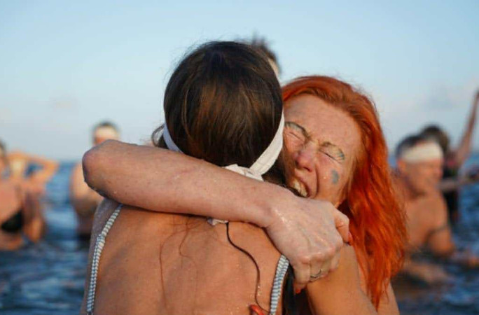 Two girls hugging in the cold water