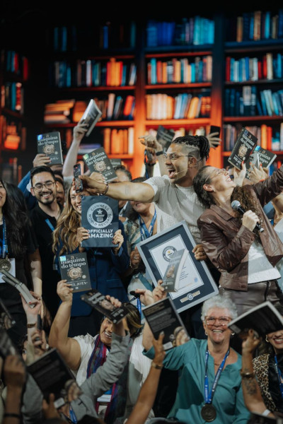 Vertical angle of Joel taking a selfie with the crowd