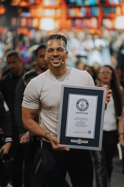 Joel holding his certificate