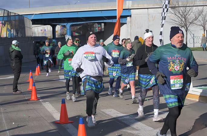 Competitors running the race in kilts