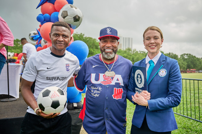 Adjudicator with soccer player and artist