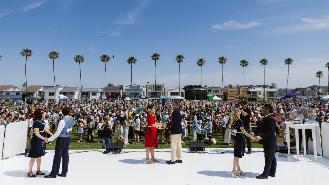 Hundreds of dancers behind three pairs of instructors in Newport Beach