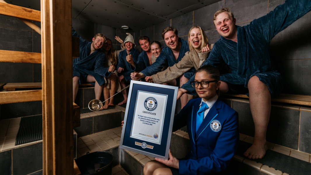 Participants in the sauna holding their GWR certificate
