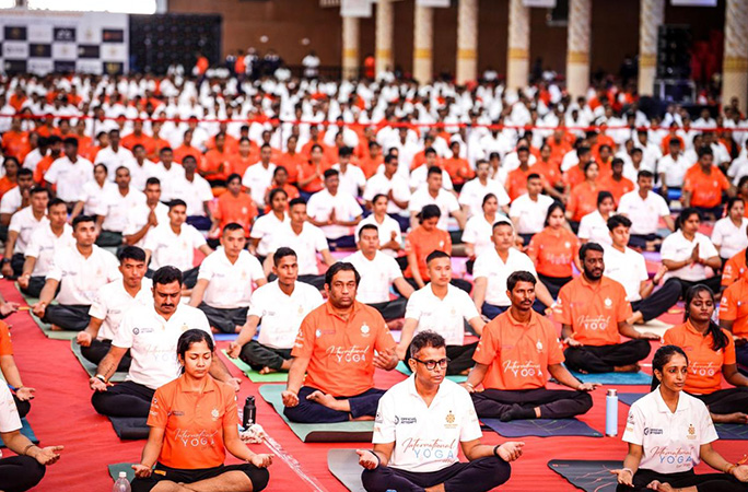 people sit crossed legs in several rows