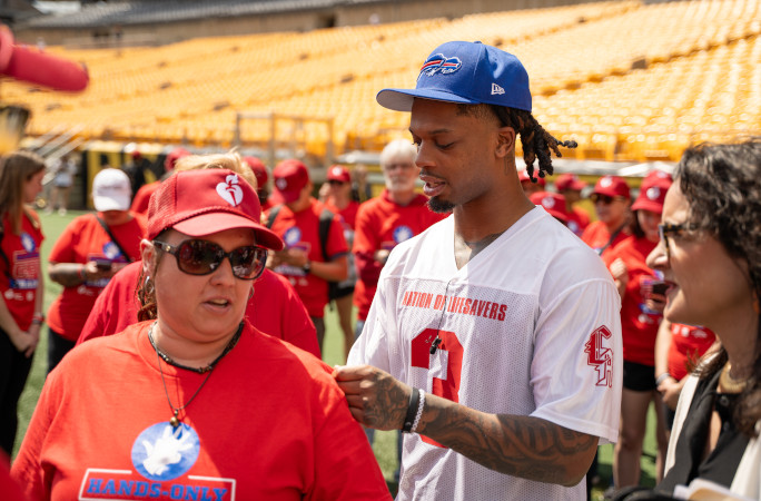 Damar Hamlin signing a fan's jersey