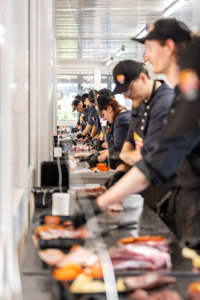 A line of butchers preparing the steaks