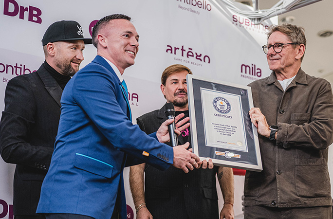 male adjudicator presents the guinness world records certificate