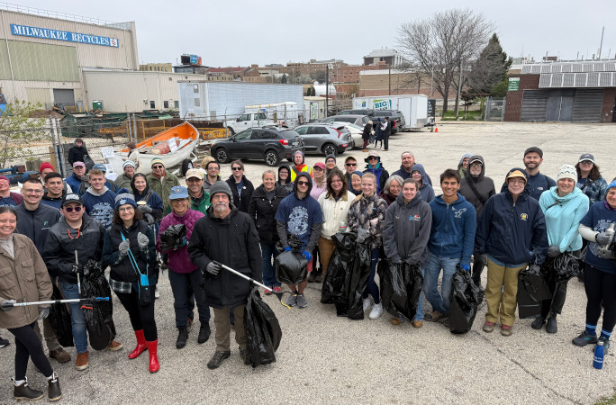 Group photo with bags of trash