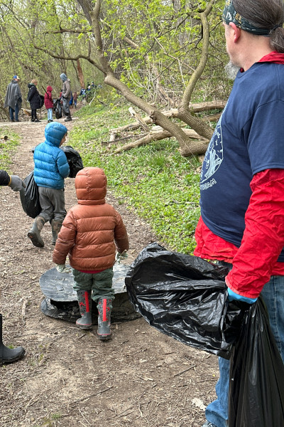 Young children walking with trash bags