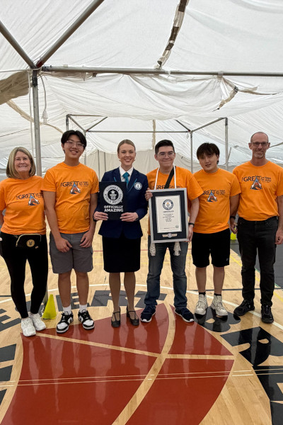 Adjudicator and event organizers with their GWR certificate