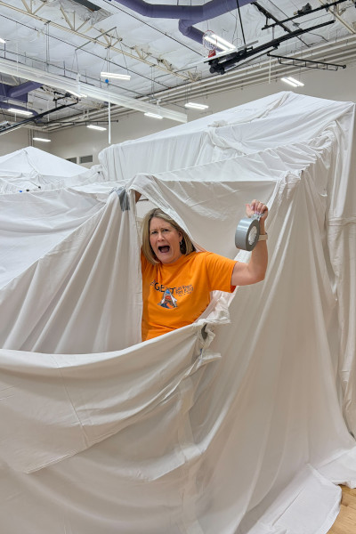 A volunteer pretending to be trapped in the giant sheets