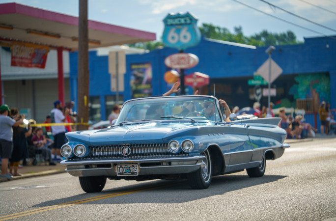 Blue convertible driving down Route 66