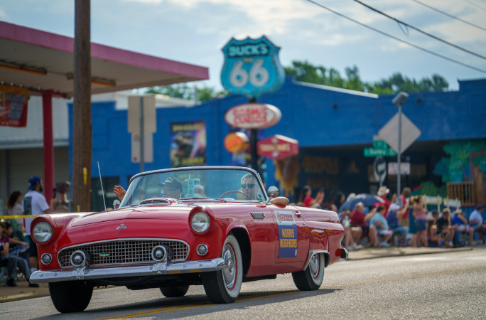 Red convertible driving down Route 66