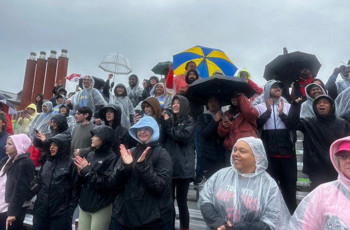 The crowd cheering in the rain