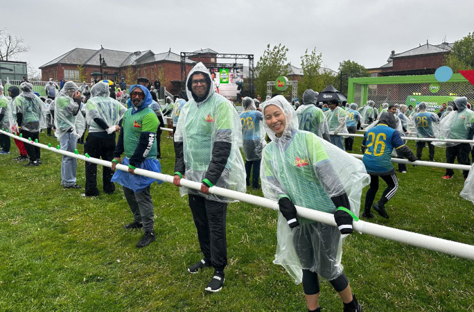 Participants smiling while playing foosball