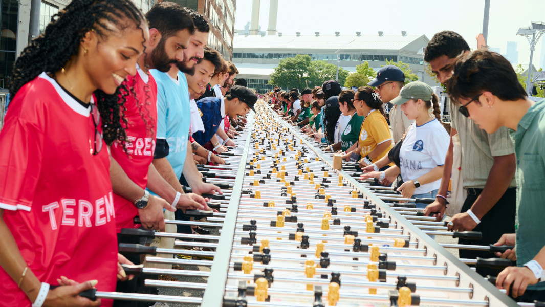 A group of people playing on the largest foosball table
