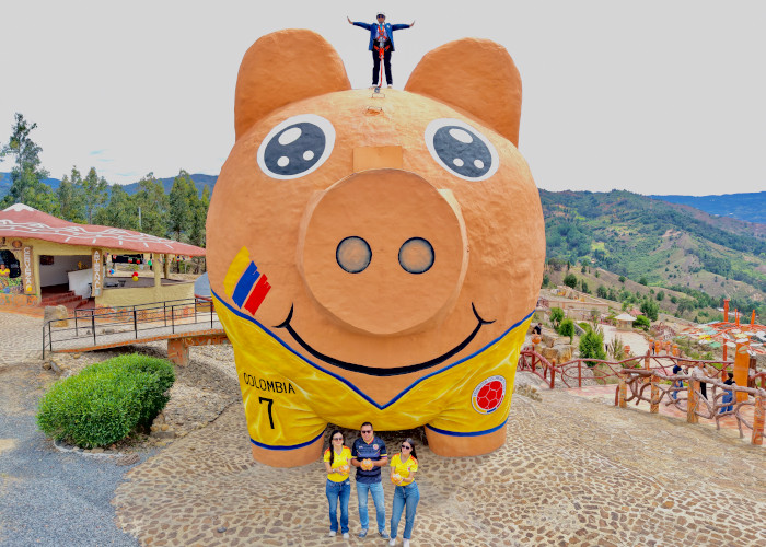 A woman standing atop the bank, with organizers below her