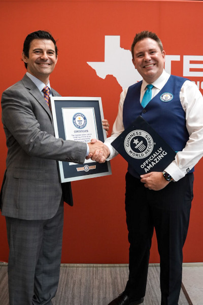 Adjudicator giving a handshake to teammember with GWR certificate