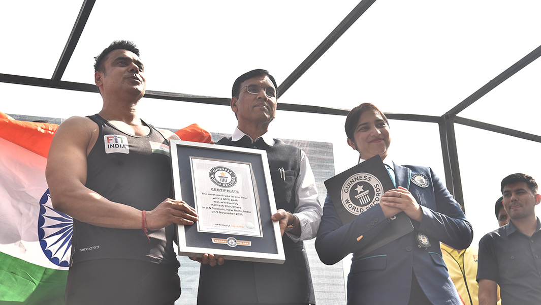 split image of man doing a push up and being presented with a guinness world records certificate