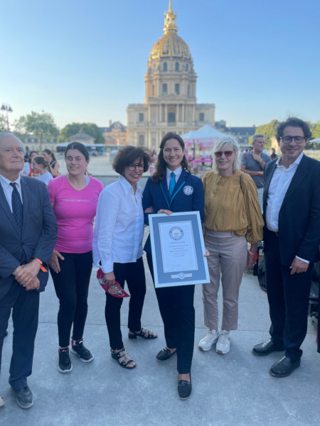 Adjudicator with the organizers and certificate in front of a church at the event