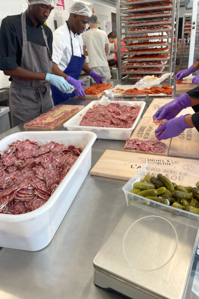 Chefs preparing the meat for the charcuterie board