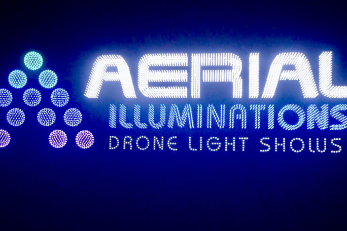 Drones displaying the Aerial Illuminations logo