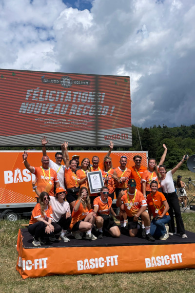 The organisers celebrating under an orange congratulations screen
